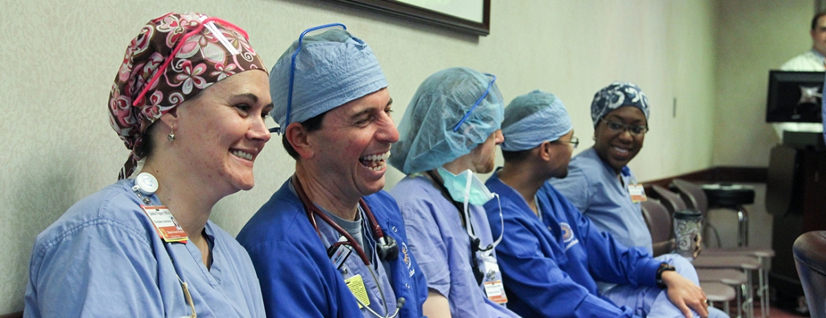 four people in hospital scrubs